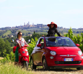 Two guests aboard the iconic Fiat 500 during one of our photo tours in San Gimignano